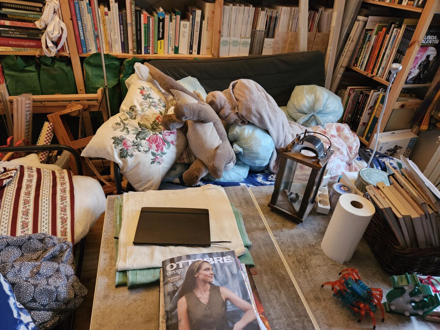 One of my couches, filled with blue plastic bags filled with filling for the future cushions. Looks extremely messy.