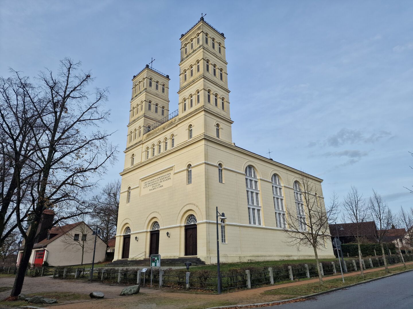A white church with a flat roof and two high towers created in the 19th century