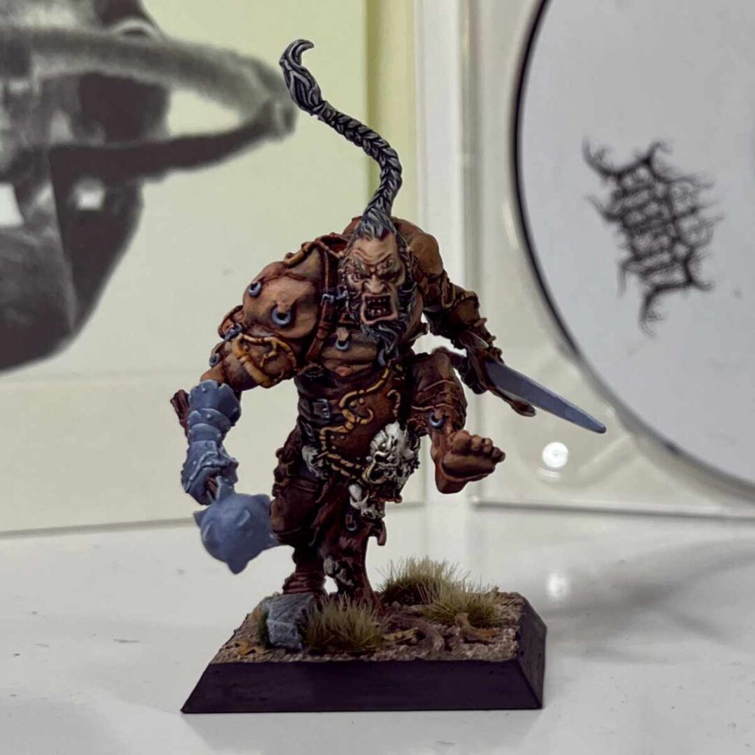 A painted miniature of an angry warrior for the Confrontation game by Rackham