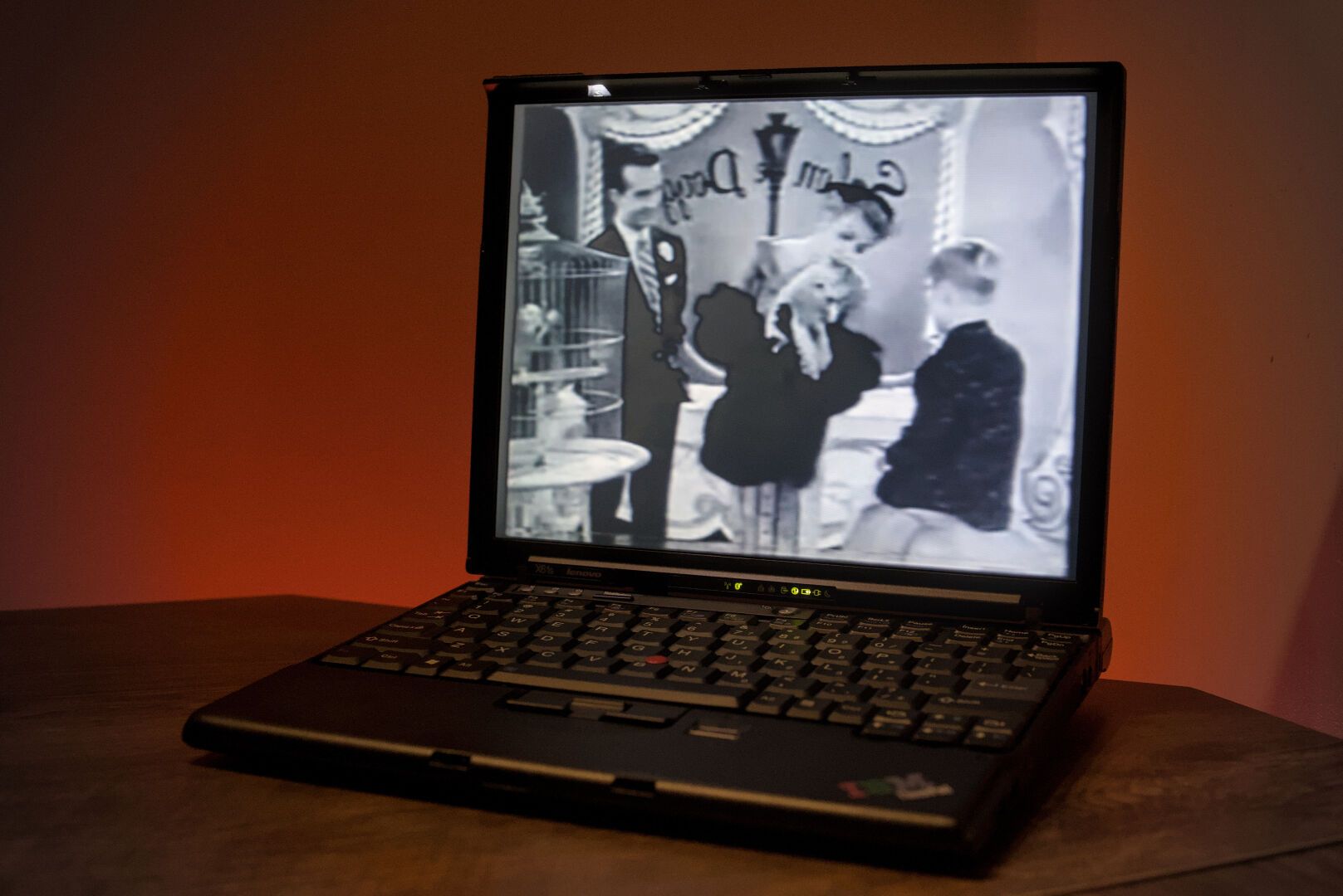 A Lenovo ThinkPad X61s with a monochromatic music video "How Much Is That Doggy in the Window?" playing