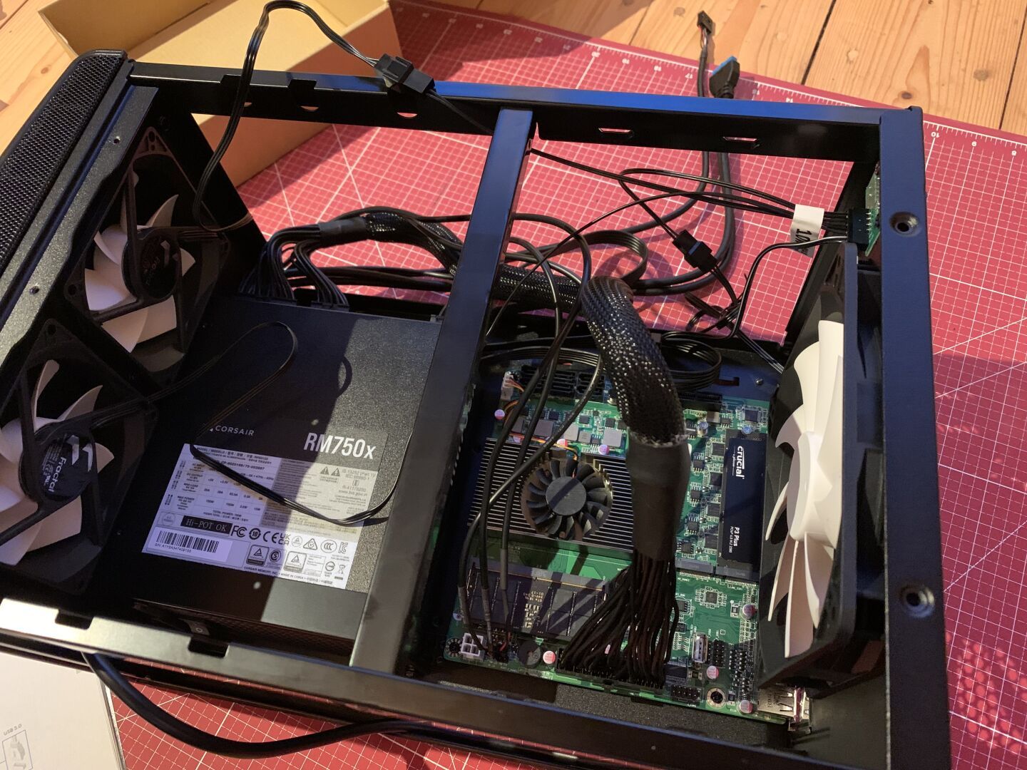 Interior of a computer with lots of cables connected to the motherboard