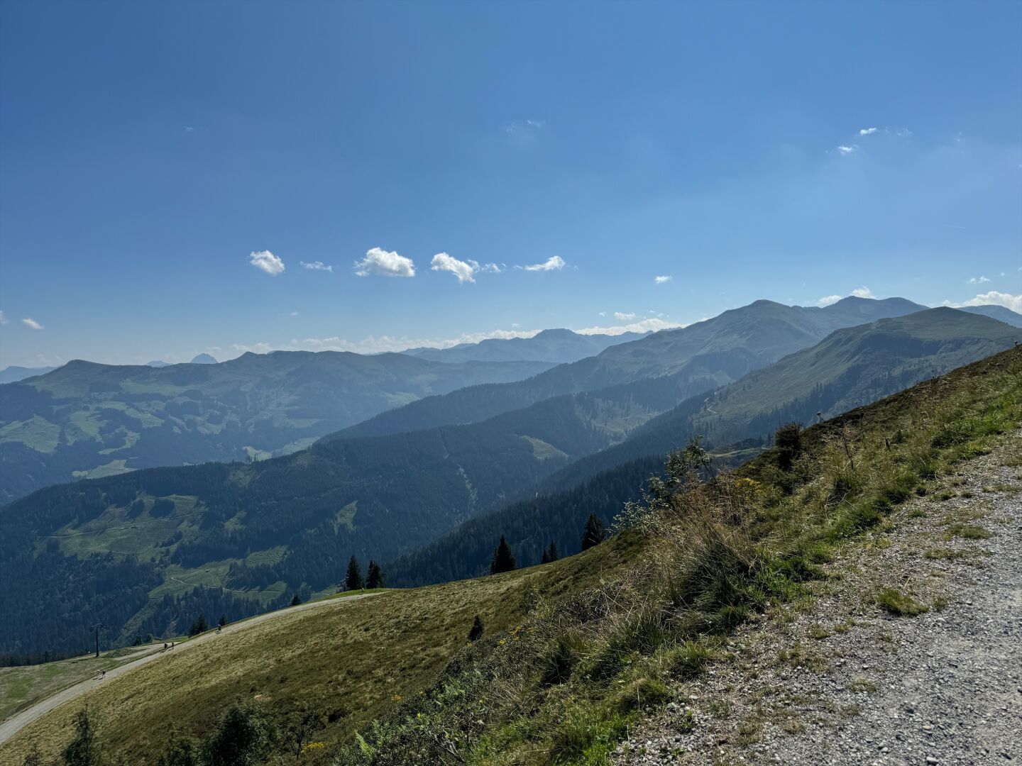View of a mountain range in Tyrol seen from a path close to the top of another mountain.