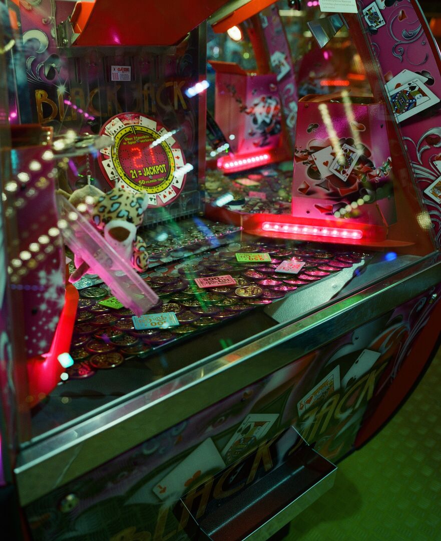 A close-up photo of a coin pusher machine at night