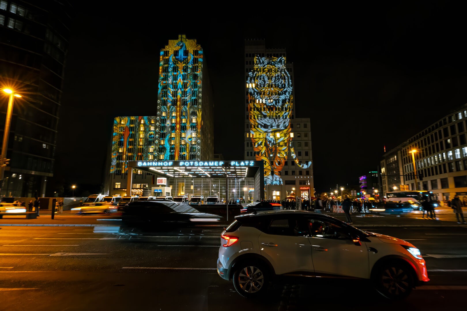Potsdamer Platz during the festival of light with cars passing by in the front during night