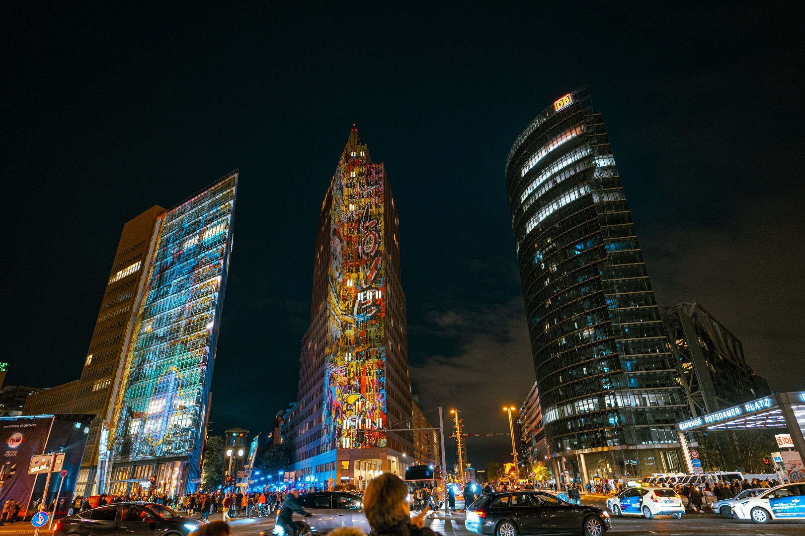 Potsdamer Platz during the festival of light with cars passing by in the front during night