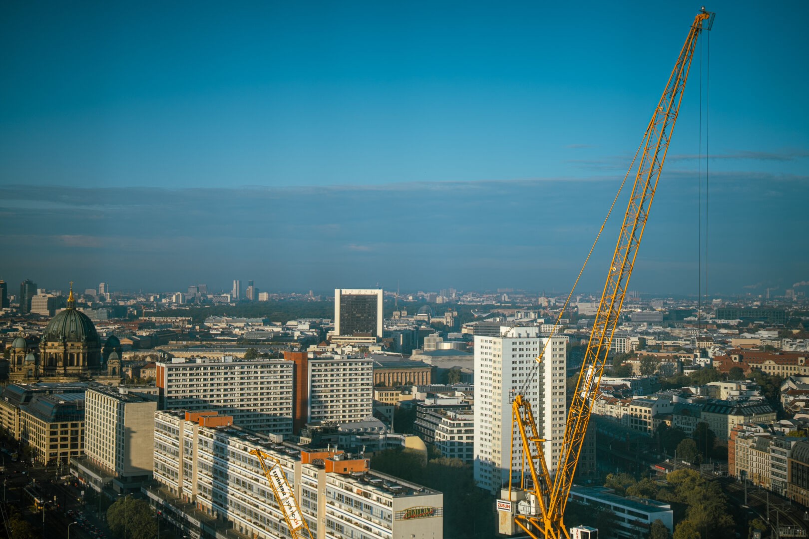 Cityscape of Berlin from a high vantage point. Multiple landmarks can be seen