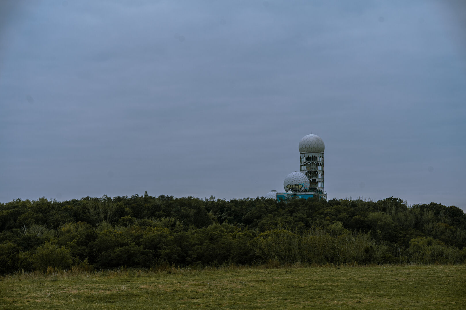 View from the Drachenberg west towards the Teufelsberg, which is a hill that was used during cold war for spying towards east-Berlin. Drachenberg is a hill in the center with a very distinct spy building, consisting of multiple white cupolas.