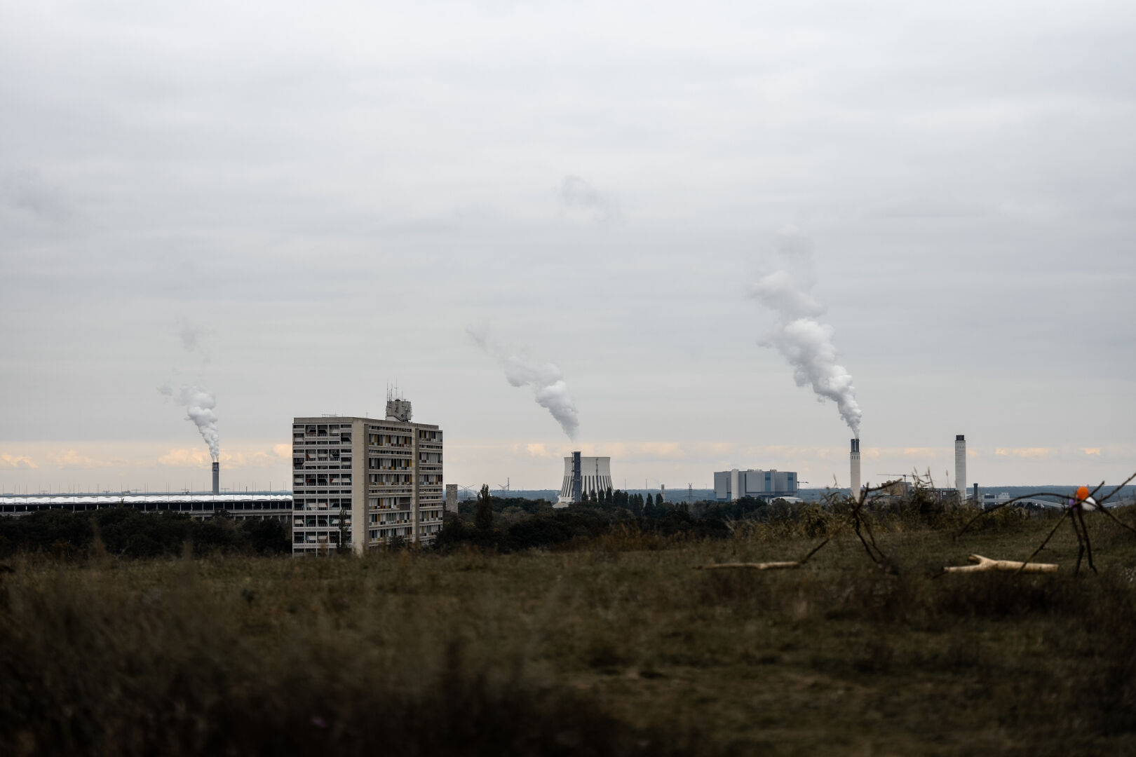 Cityscape view from the Drachenberg towards the north. Cloudy weather, smoke emerging from chimneys above the cityscape can be clearly seen.