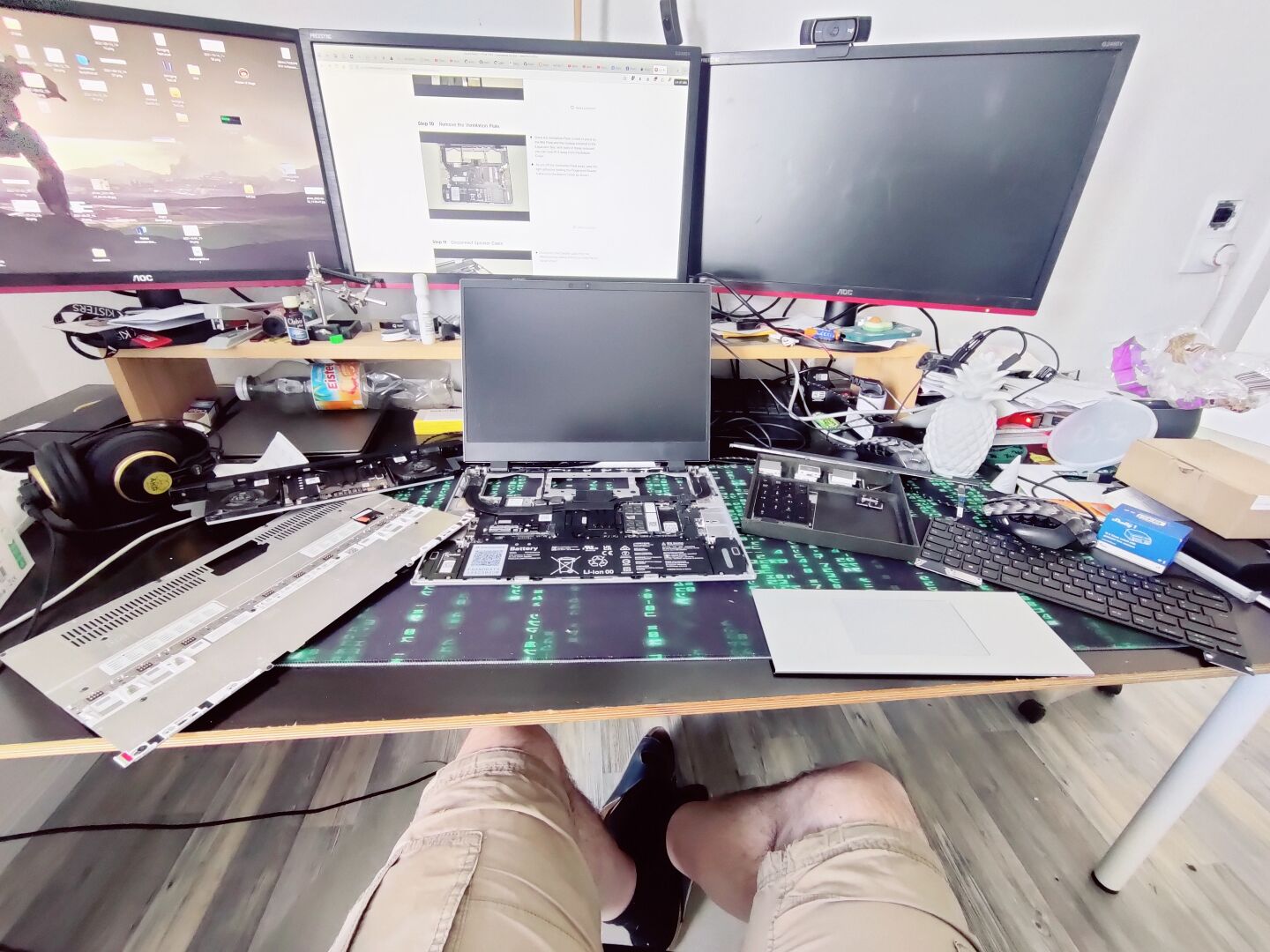 a partially disassembled Framework 16 Laptop on my chaotic desk